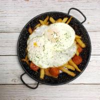 Huevos Rotos con Chorizo · 2 sunny side up eggs over Spanish sausage and french fries.