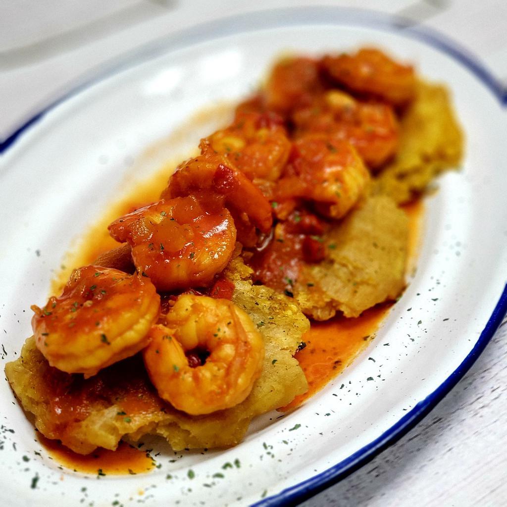 Tostones con Camarones · Plantain fritters topped with stewed shrimp. 3 units.