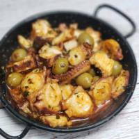 Pulpo al Ajillo · Chunks of octopus sauteed with olives and slices of garlic in olives oil.