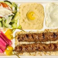 Lule Kabob Plate · Ground beef kabob served with french fries or rice, salad, hummus, garlic sauce, pickles and...