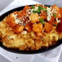 Cast Iron Mac Buffalo Style · Baked shells topped with herbed Ritz cracker crumbs. Fried chicken, scallions, blue cheese c...