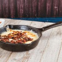 Queso Fundido · Melted Monterrey cheese and chorizo - seasoned pork, served with the order of hand made tort...