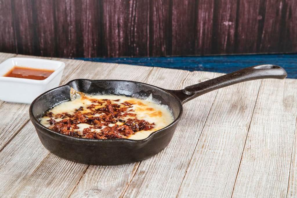 Queso Fundido · Melted Monterrey cheese and chorizo - seasoned pork, served with the order of hand made tortillas.