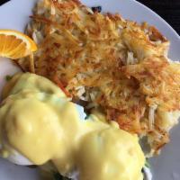 Crab Cake Benedict · Poached eggs on crab cakes with spinach, avocado and topped with Hollandaise sauce. Served w...