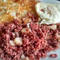 Corned Beef Hash · Corned beef, onions and Swiss cheese. Tossed with crispy potatoes and topped with 2 eggs. Se...