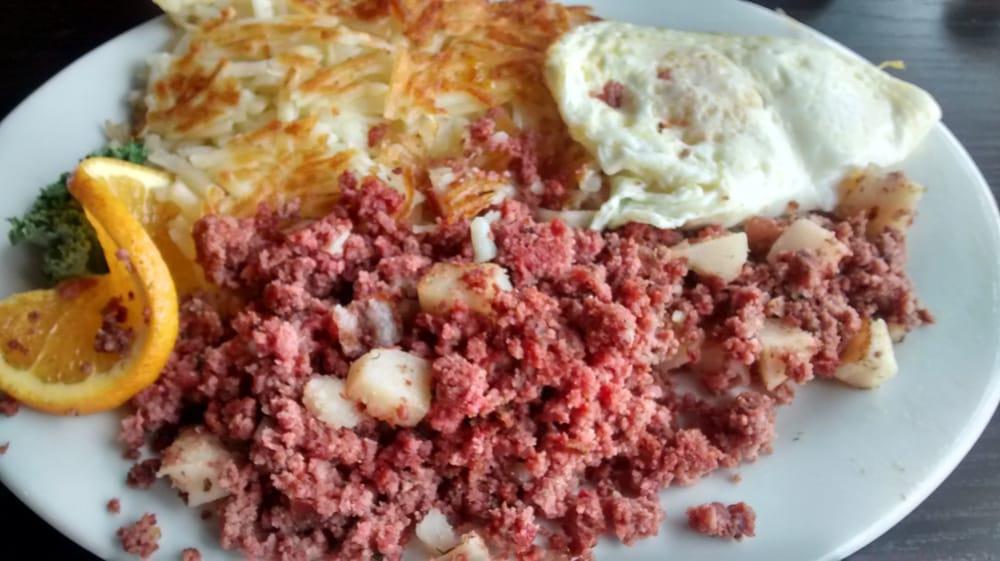 Corned Beef Hash · Corned beef, onions and Swiss cheese. Tossed with crispy potatoes and topped with 2 eggs. Served with choice of toast or bagel.