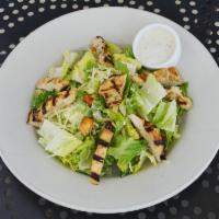 Caesar Salad · Chopped romaine hearts tossed with croutons and Caesar dressing topped with shaved Parmesan ...