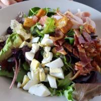 Cobb Salad · Mixed greens and seasoned croutons topped with crumbled blue cheese, chopped egg, smoked tur...
