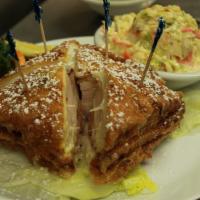 Monte Cristo Sandwich · Ham, turkey and Swiss cheese on challah bread dipped in egg and fried. Served with fresh fru...