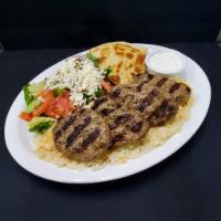 Kofte Kebab · Grilled seasoned ground beef with spices and herbs. Served with rice, Greek salad, pita, and...