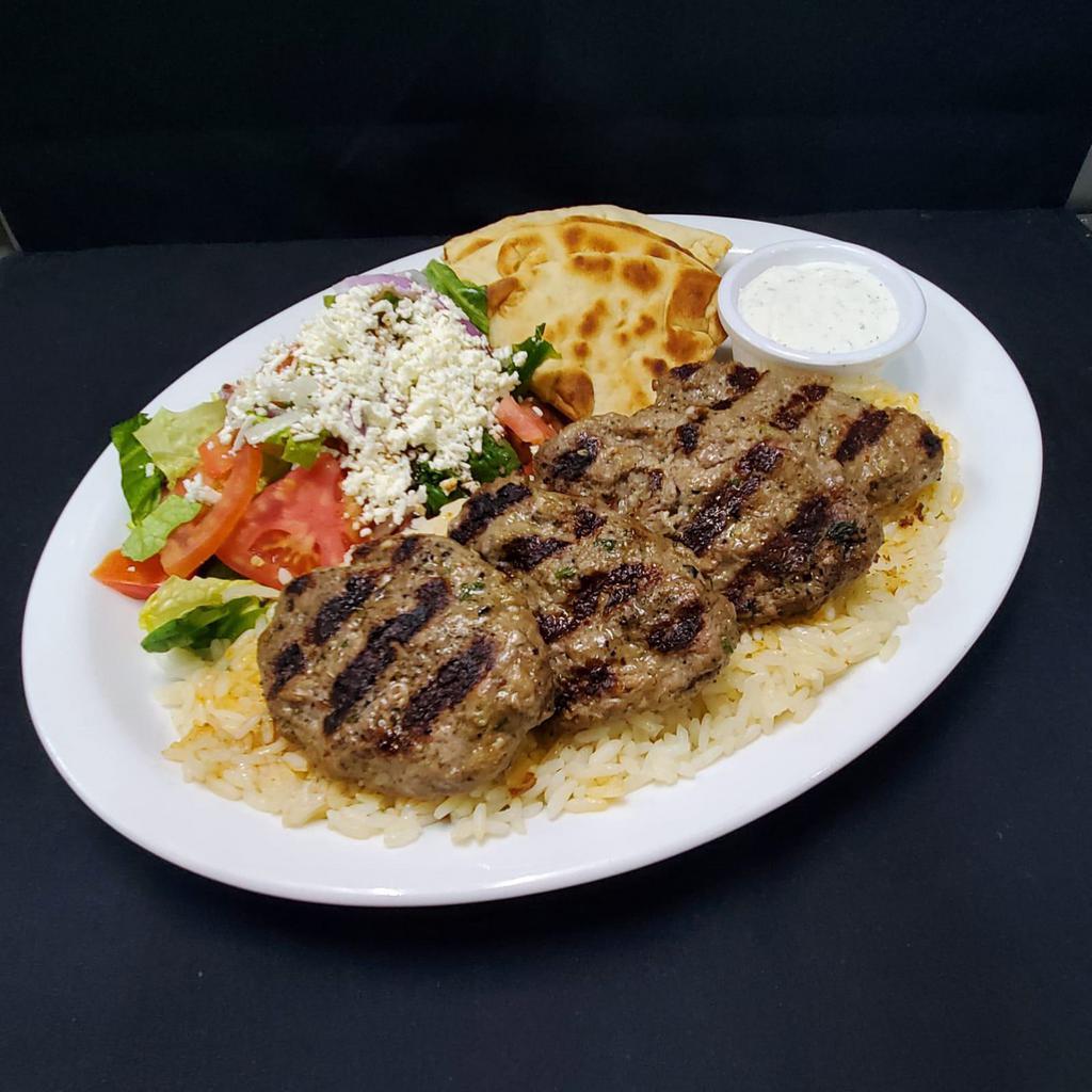 Kofte Kebab · Grilled seasoned ground beef with spices and herbs. Served with rice, Greek salad, pita, and tzatziki sauce.