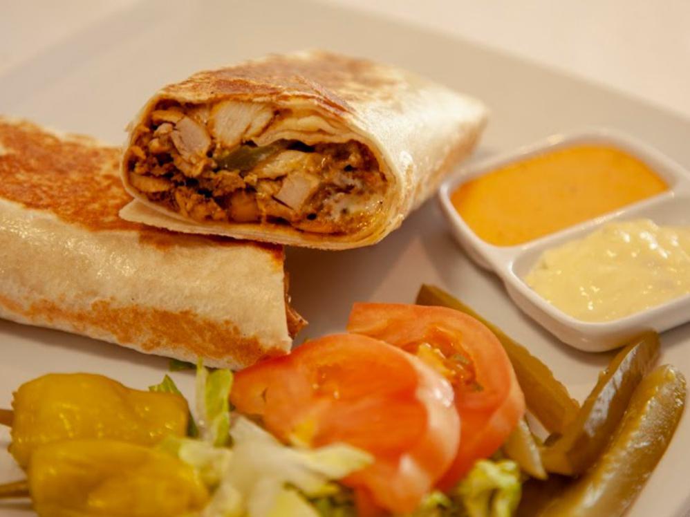 Panini Chicken Shawarma · Thin sliced Chicken Shawarma Wrapped in Saj thin Bread with Pickles  and House Garlic  Sauce.  grilled on flat hot top.