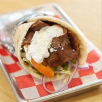 Gyro Wrap  (in Mediterranean wrap) · Beef and lamb gyro served with lettuce, tomato, onion, feta cheese and tzatziki sauce in Med...