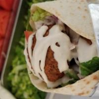 Falafel Wrap  · Falafel served with hummus, lettuce, tomato, onion and tahini sauce. Vegetarian. wrapped in ...
