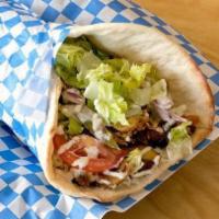Lamb Shawarma Wrap  · Oven Roasted Leg of Lamb spiced and served with lettuce, tomato, onion and  tahini sauce.  w...