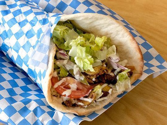 Lamb Shawarma Wrap  · Oven Roasted Leg of Lamb spiced and served with lettuce, tomato, onion and  tahini sauce.  wrapped in house made pita . 