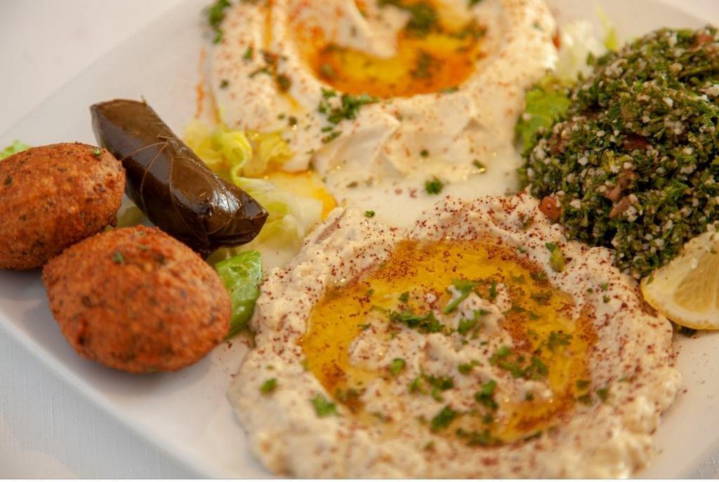 Veggie Mezza with Pita Bread · Hummus, baba ghanoush, falafel, grape leaves, and tabbouleh. Vegetarian.