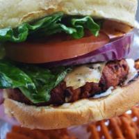 Vegetarian Burger · Vegan burger topped with vegan mayo, lettuce, and tomato on a Hawaiian bun.