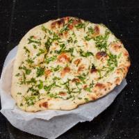 Garlic Naan · Bread topped with fresh minced garlic cloves cooked in our clay oven.