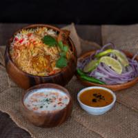 Chicken Dum Biryani · Hyderabadi style spicy chicken on the bone and basmati rice served in a dough sealed pot.