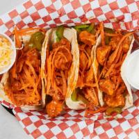 Buffalo Chicken Tacos · Three Tacos on corn tortillas with Buffalo chicken, celery, carrots and cilantro with your c...