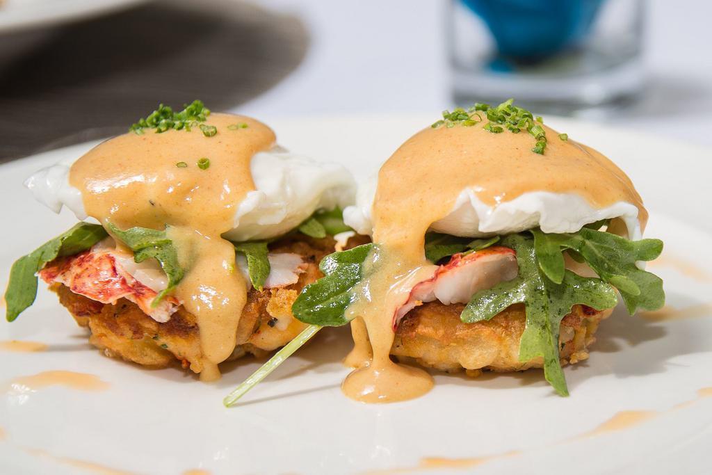 Lobster Benedict · Baked lobster, topped with poached organic eggs herb Hollandaise sauce, hash brown and house salad.