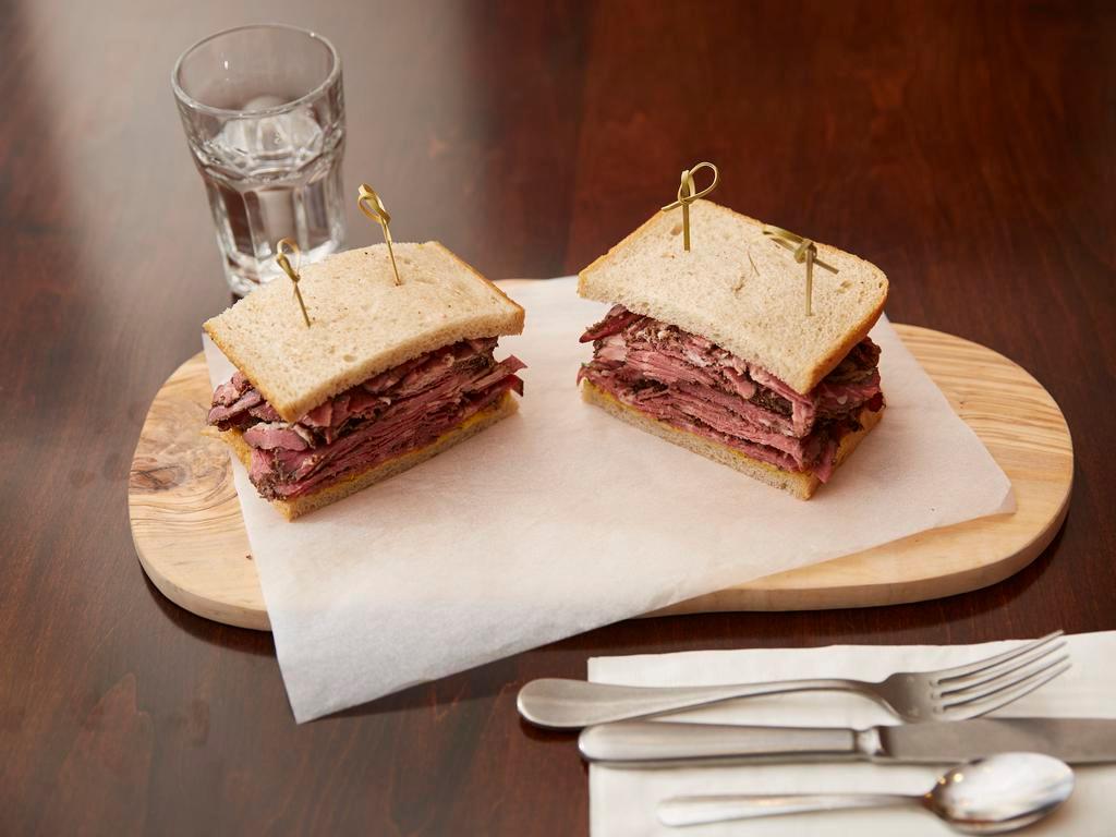 Pastrami Sandwich · Half pound of naval pastrami, served on rye bread with mustard and sauerkraut and our famous pickles.