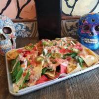 Large Nachos · Layers of freshly fried chips, refried beans, corn salsa, black olives, queso fresco, Pico d...