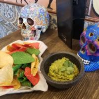 Traditional Guacamole · Fresh avocado, red onion, cilantro, lime and jalapenos. Served with fresh chips.