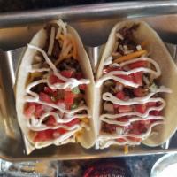 Gringo Tacos · Tacos with seasoned beef, lettuce, cilantro, Pico de Gallo, and blended Mexican cheeses on f...