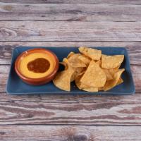 Chips and Queso · Latin style infused queso with homemade tortilla chips. (Add carne asada, chicken or chorizo...
