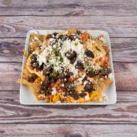 Nachos · Chicken or beef. Beans, queso, guacamole, pico, sour cream and queso fresco. Served with hom...