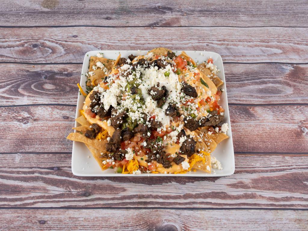 Nachos · Chicken or beef. Beans, queso, guacamole, pico, sour cream and queso fresco. Served with homemade chips.