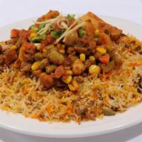 Vegetable Biryani · Vegetables flavored with spices cooked with basmati rice. It is served with raita.