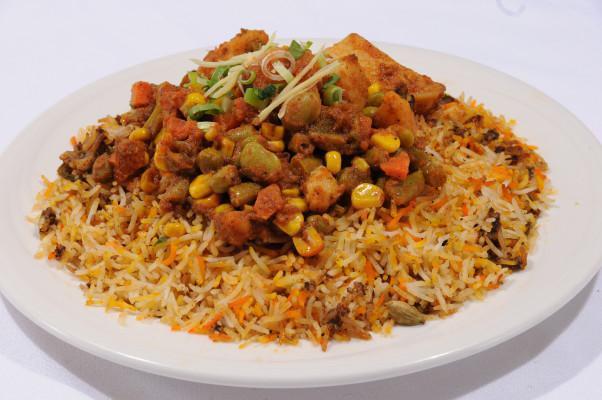 Vegetable Biryani · Vegetables flavored with spices cooked with basmati rice. It is served with raita.