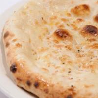 Butter Naan · Whit flatbread baked in a tandoor clay oven with butter.