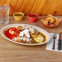 Huevos Divorciados  · 2 eggs with chilaquiles, 1 with red sauce and 1 with green sauce. 