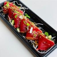 Seared Ahi 6pcs · Sashimi grade tuna coated with pepper then seared, topped with spicy sauce, scallions, sesam...