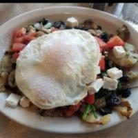 Greek Skillet · Herb red potatoes topped topped with sauteed spinach, onions, tomatoes, basil, feta & two eg...