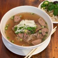 Beef Pho Soup · Filet mignon, meatball and smoked brisket. Topped with cilantro, green onions and white onio...