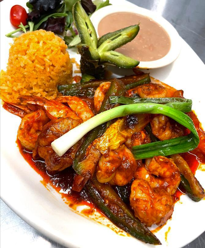 Fajitas Fuego de Pollo  · Marinated strips of chicken breast sautéed with jalapeños, serrano peppers, grilled onions, and tomatoes. A side of rice, beans, salad, and tortillas is included. 