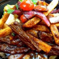Saltado · Stripped beef or chicken sauteed with fries, onion and tomato. Served with rice. 