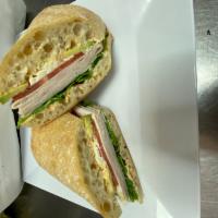 Turkey Bistro Melt · Roasted turkey, goat cheese, avocado, baby arugula, tomatoes and bistro spread.