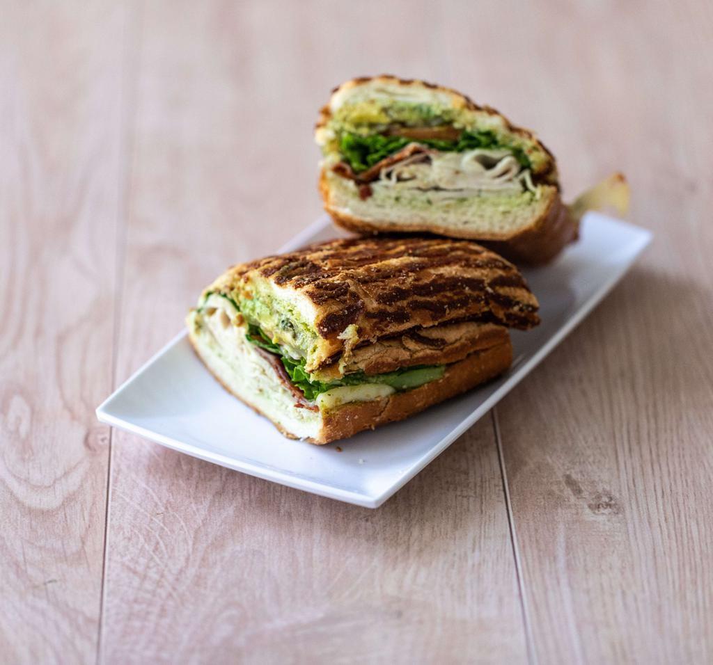 Roma's Club · Turkey, bacon, avocado, Swiss cheese and pesto aioli spread on Dutch crunch. Includes lettuce, tomatoes, red onions, pickles and jalapeno spread.