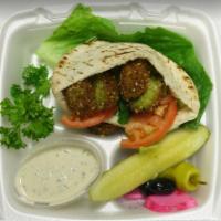 Traditional Falafel Sandwich (Vegan) · Falafel, tomatoes and lettuce in a white, pocket Pita. Served with a side of Tahini Sauce (c...