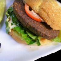Falafel Burger ·  Our homemade Falafel served as a burger, topped with lettuce, tomatoes and Hommus on a corn...