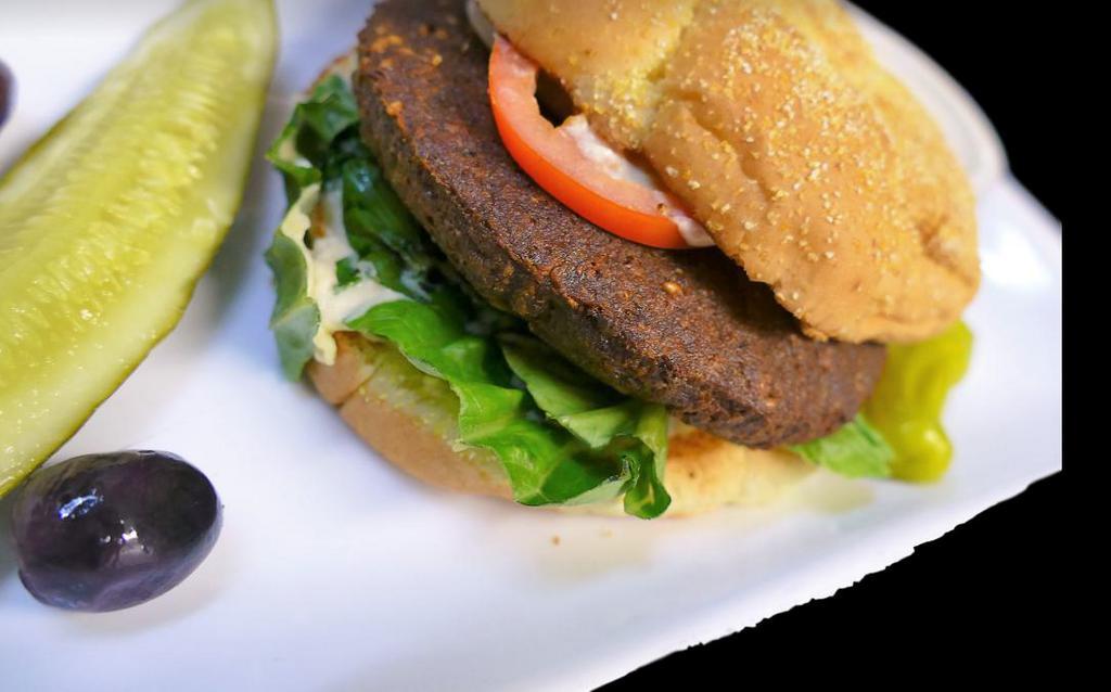 Falafel Burger ·  Our homemade Falafel served as a burger, topped with lettuce, tomatoes and Hommus on a corn-dusted bun (vegan)