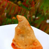Indian Samosa (1 pc.) · Contains potatoes, onions, peas and spices (vegan)