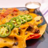 Baked Nachos · Homemade beef chili, jalapenos, cheddar and pepper jack cheese, salsa and sour cream