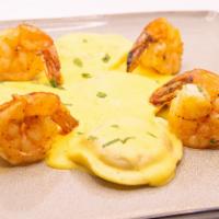 Lobster Ravioli · Blackened shrimp, chives, saffron cream sauce.